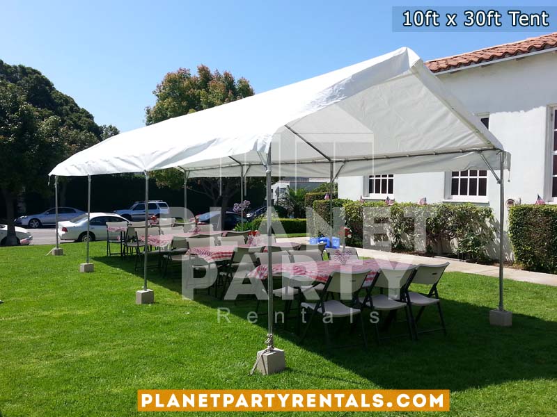 10ft x 30ft Tent on grass with rectangular tables and white chairs| Tent rentals San Fernando Valley